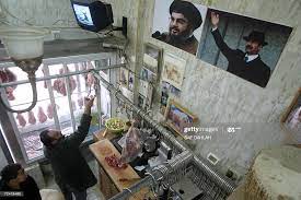 A poster of former Iraqi President Saddam Hussein is hung next to... News  Photo - Getty Images